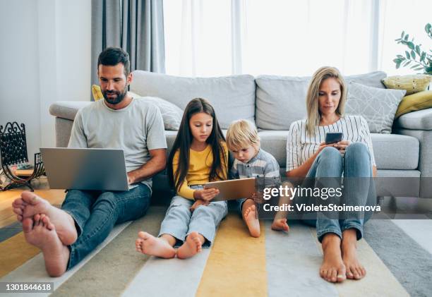 relaxing at home with wireless technology. - mother and son using tablet and laptop stock pictures, royalty-free photos & images