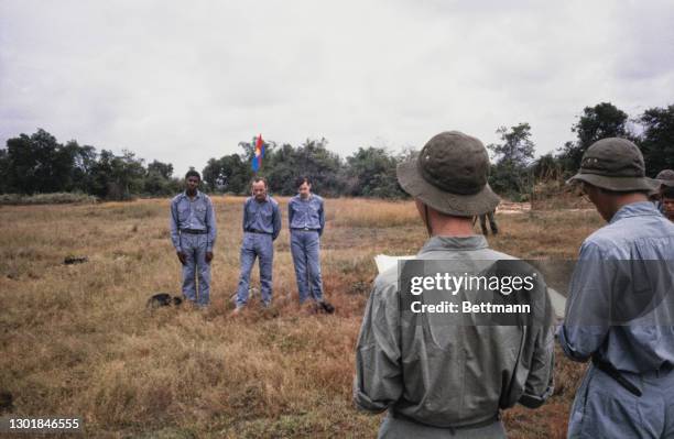 United States prisoners of war James Brigham, Thomas Jones and Donald Smith, each wearing blue trousers and blue shirts, after their release from...