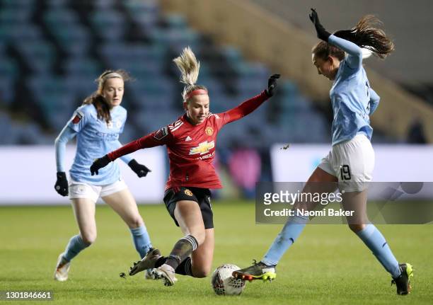 Jackie Groenen of Manchester United tackles Caroline Weir of Manchester City during the Barclays FA Women's Super League match between Manchester...