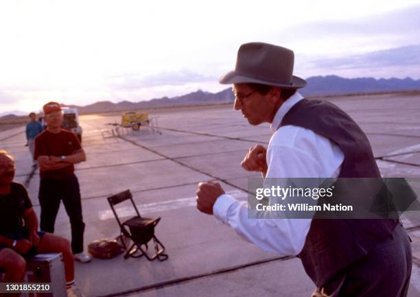 American actor, playwright, author, screenwriter, and director Sam Shepard stands in a fighting stance on the set of the 1991 English-language drama...