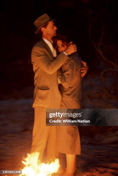 American actor, playwright, author, screenwriter, and director Sam Shepard and American film actress Traci Lind hug during a scene on the set of the...