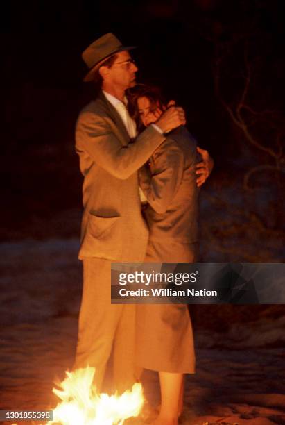 American actor, playwright, author, screenwriter, and director Sam Shepard and American film actress Traci Lind hug during a scene on the set of the...
