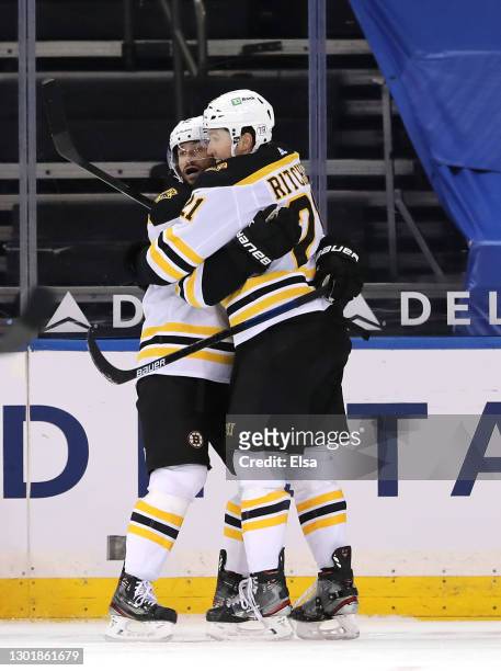 Nick Ritchie of the Boston Bruins is congratulated by Craig Smith after he scored a goal in the second period against the New York Rangers at Madison...
