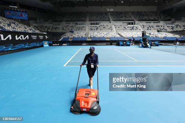 Members of staff attend to the court on John Cain Arena during day six of the 2021 Australian Open at Melbourne Park on February 13, 2021 in...