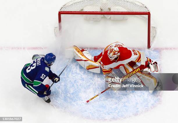 Jacob Markstrom of the Calgary Flames makes a save off the shot of Bo Horvat of the Vancouver Canucks during their NHL game at Rogers Arena on...