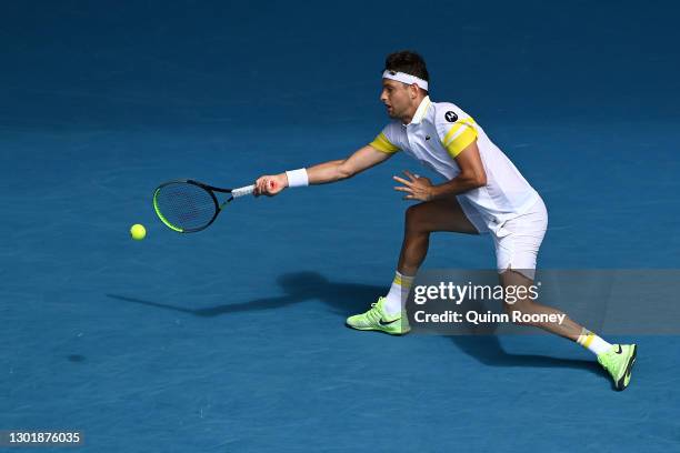 Filip Krajinovic of Serbia plays a forehand in his Men's Singles third round match against Daniil Medvedev of Russia during day six of the 2021...