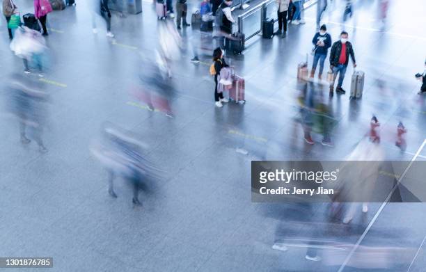 the flow of people at the airport - airport crowd stock pictures, royalty-free photos & images