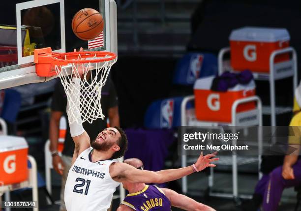 Tyus Jones of the Memphis Grizzlies shoots defended by Alex Caruso of the Los Angeles Lakers at Staples Center on February 12, 2021 in Los Angeles,...