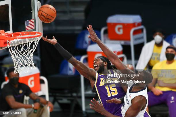 Montrezl Harrell of the Los Angeles Lakers shoots a layup defended by Gorgui Dieng of the Memphis Grizzlies at Staples Center on February 12, 2021 in...