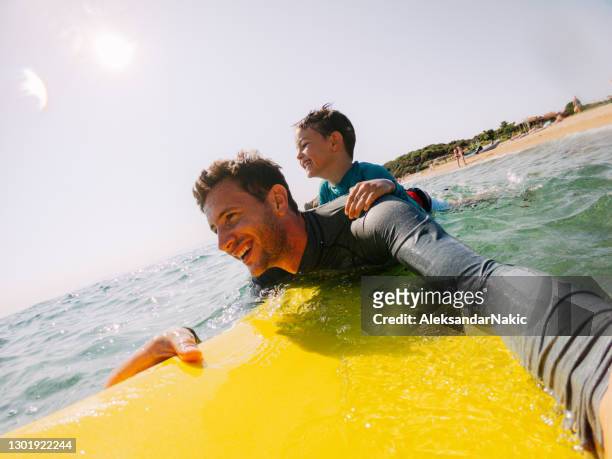 surfing with dad - extreme sports kids stock pictures, royalty-free photos & images