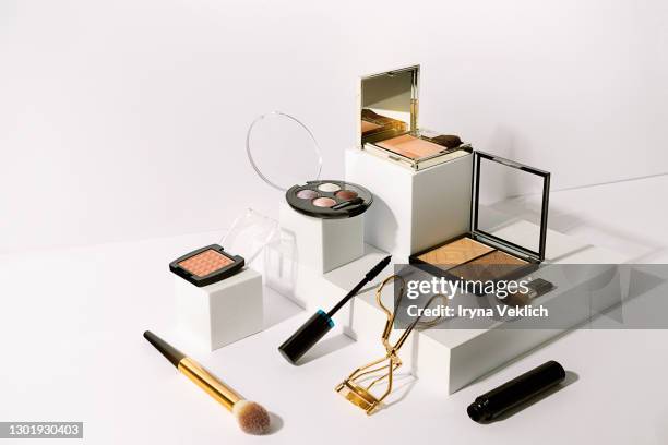 various make-up products on podiums white background. - lidschatten stock-fotos und bilder