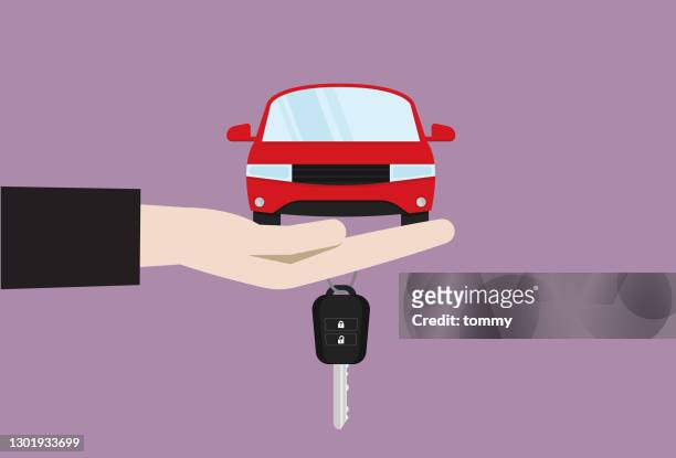 hand holds a car and a car key - vehicle key stock illustrations