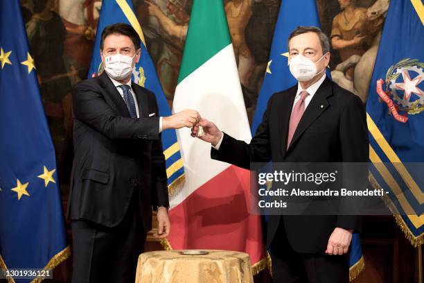 Italy's new Prime Minister Mario Draghi rings the received bell from outgoing Prime Minister Giuseppe Conte, prior the first Ministry Council meeting...