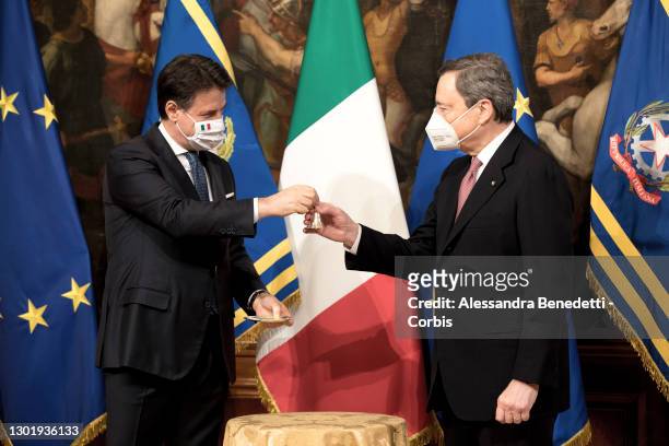Italy's new Prime Minister Mario Draghi rings the received bell from outgoing Prime Minister Giuseppe Conte, prior the first Ministry Council meeting...