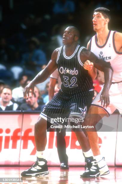 Shaquille O'Neal of the Orlando Magic and Gheorghe Muresan the Washington Bullets fight for position during a NBA basketball game on January 29, 1994...