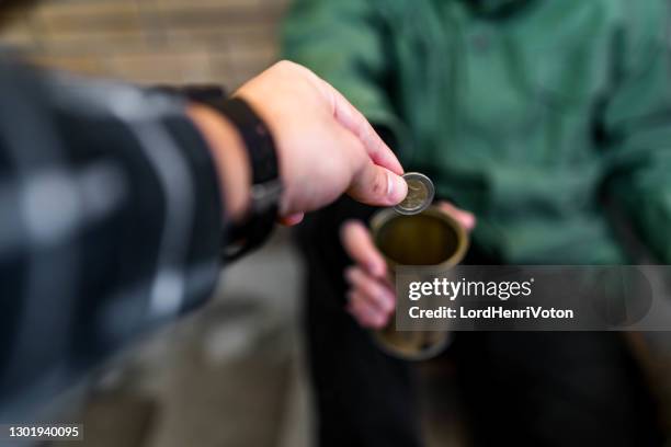 homeless man receiving money - pleading stock pictures, royalty-free photos & images