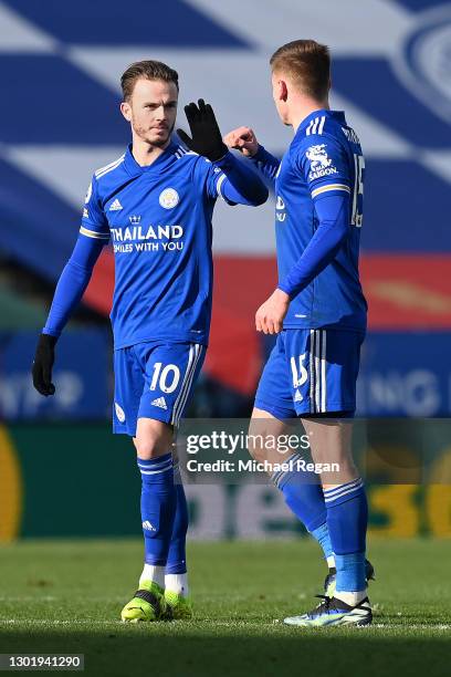James Maddison of Leicester City celebrates with teammate Harvey Barnes after scoring his team's first goal during the Premier League match between...
