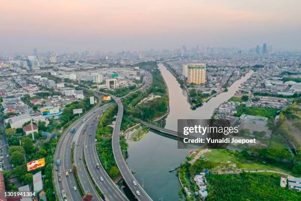 jakarta citiscape, road and river in capital cities indonesia - yakarta fotografías e imágenes de stock