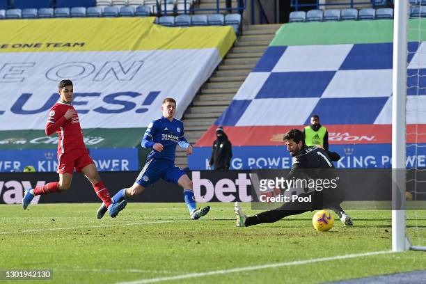 Harvey Barnes of Leicester City scores his team's third goal past Alisson of Liverpool during the Premier League match between Leicester City and...