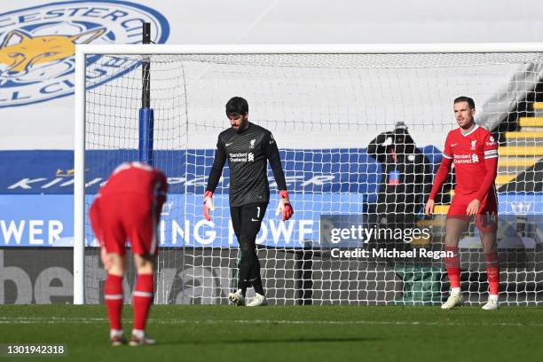 Alisson and Jordan Henderson of Liverpool look dejected after conceding a third goal during the Premier League match between Leicester City and...