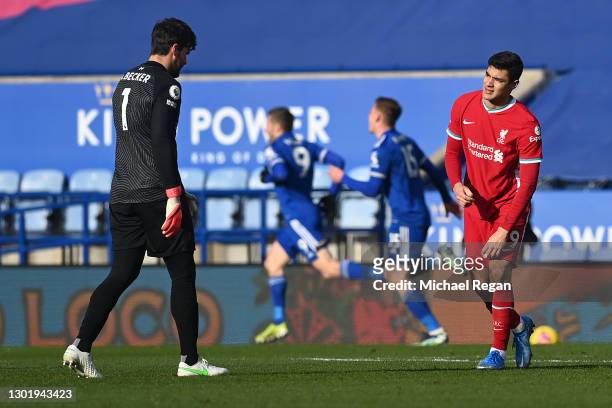 Alisson of Liverpool speaks with Ozan Kabak of Liverpool after they concede a second goal during the Premier League match between Leicester City and...