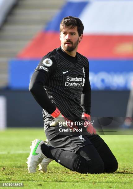 Alisson of Liverpool reacts after conceding the first Leicester City goal during the Premier League match between Leicester City and Liverpool at The...