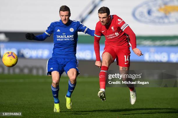 Jordan Henderson of Liverpool passes the ball whilst under pressure from Jamie Vardy of Leicester City during the Premier League match between...