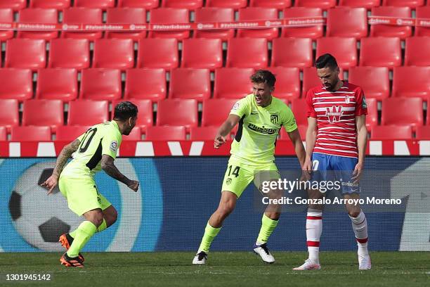 Angel Correa of Atletico de Madrid celebrates with teammate Marcos Llorente after scoring his team's second goal during the La Liga Santander match...