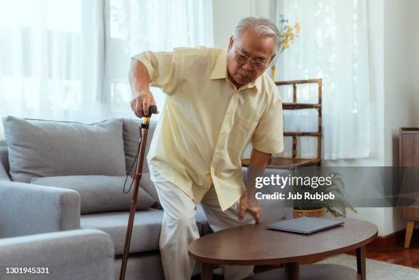old retired gentleman with chronic knee problems and pain - arthritis stock pictures, royalty-free photos & images