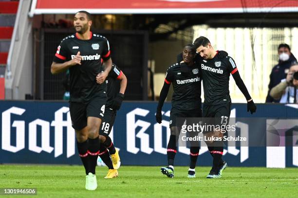 Lucas Alario of Bayer 04 Leverkusen celebrates with team mate Moussa Diaby after scoring their side's first goal during the Bundesliga match between...