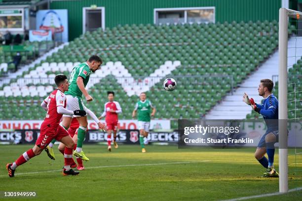 Milos Veljkovic of SV Werder Bremen has a header saved by Florian Mueller of Sport-Club Freiburg during the Bundesliga match between SV Werder Bremen...