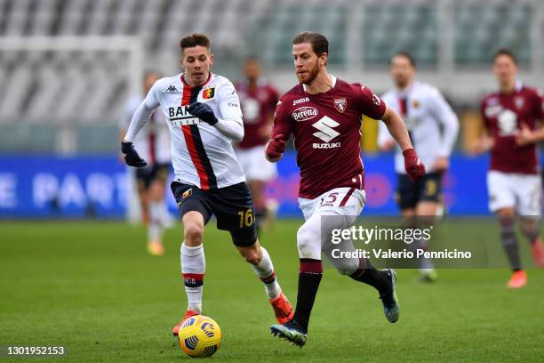 Cristian Ansaldi of Torino FC runs with the ball under pressure from Miha Zajc of Genoa C.F.C. During the Serie A match between Torino FC and Genoa...