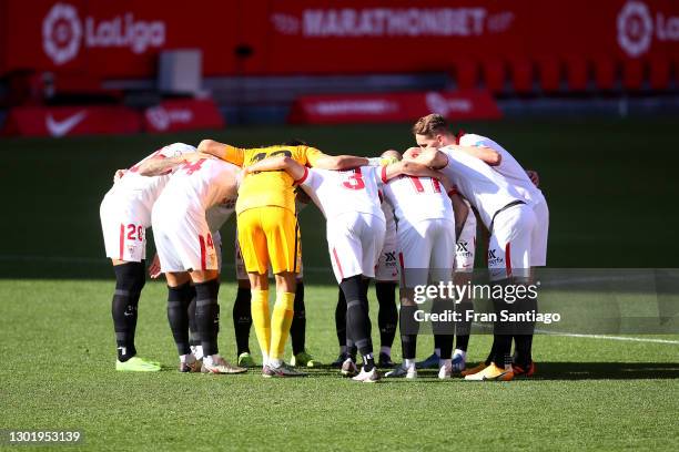 Sevilla players form a team huddle prior to the La Liga Santander match between Sevilla FC and SD Huesca at Estadio Ramon Sanchez Pizjuan on February...