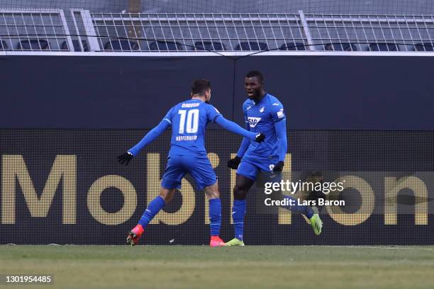 Ihlas Bebou of TSG 1899 Hoffenheim celebrates with teammate Munas Dabbur after scoring his team's second goal during the Bundesliga match between...