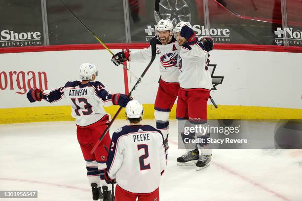 Michael Del Zotto of the Columbus Blue Jackets celebrates a goal with teammates during a game against the Chicago Blackhawks at the United Center on...