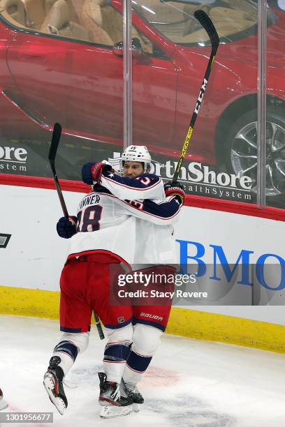 Michael Del Zotto of the Columbus Blue Jackets celebrates a goal with Boone Jenner during a game against the Chicago Blackhawks at the United Center...