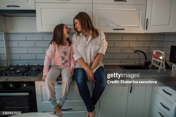 cute little kid girl and smiling mom laughing embracing enjoying spending time together, happy mother holding child daughter having fun playing hugging cuddling bonding playing feeling love joy - family law stockfoto's en -beelden