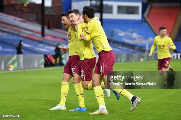 Matthew Lowton of Burnley celebrates with teammates Ashley Westwood and Dwight McNeil after scoring his team's third goal during the Premier League...