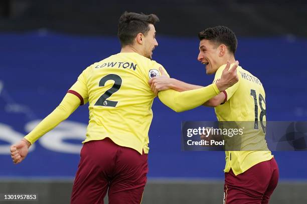 Matthew Lowton of Burnley celebrates with teammate Ashley Westwood after scoring his team's third goal during the Premier League match between...