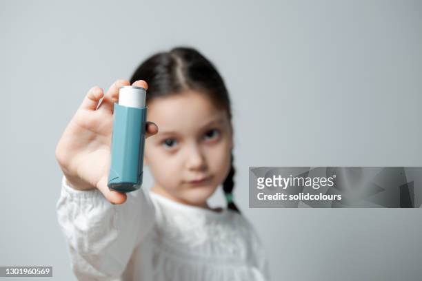 asthma inhaler - asthma inhaler child stock pictures, royalty-free photos & images