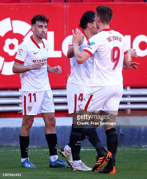 Munir of Sevilla celebrates with teammates Karim Rekik and Luuk de Jong after scoring his team's first goal during the La Liga Santander match...