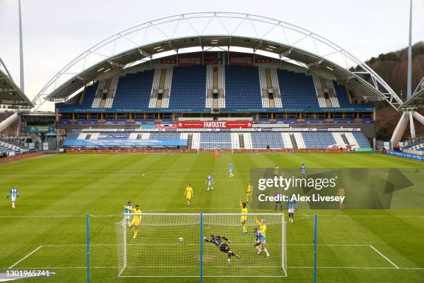 Juninho Bacuna of Huddersfield Town scores their side's first goal past Ryan Allsop of Wycombe Wanderers during the Sky Bet Championship match...