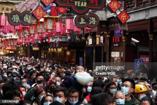 People wearing face masks visit Yuyuan Garden on the second day of the Chinese New Year, the Year of the Ox, on February 13, 2021 in Shanghai, China.