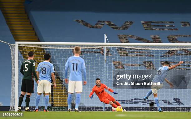Rodrigo of Manchester City scores their side's first goal from the penalty spot past Hugo Lloris of Tottenham Hotspur during the Premier League match...
