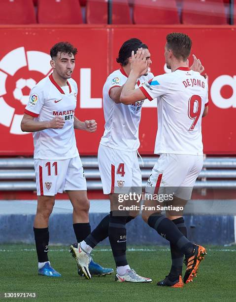 Munir El Haddadi of Sevilla FC celebrates scoring a goal with team mates during the La Liga Santander match between Sevilla FC and SD Huesca at...