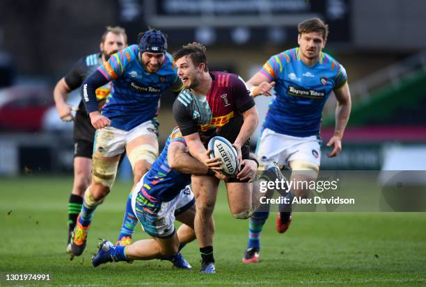 Will Evans of Harlequins is tackled by Jaco Taute of Leicester Tigers prior to offloading to Marcus Smith who went on to score his sides second try...