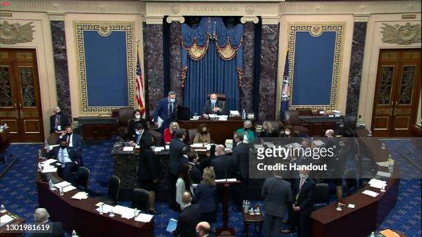 In this screenshot taken from a congress.gov webcast, House impeachment managers and defense counsel hold a side bar during closing arguments on the...