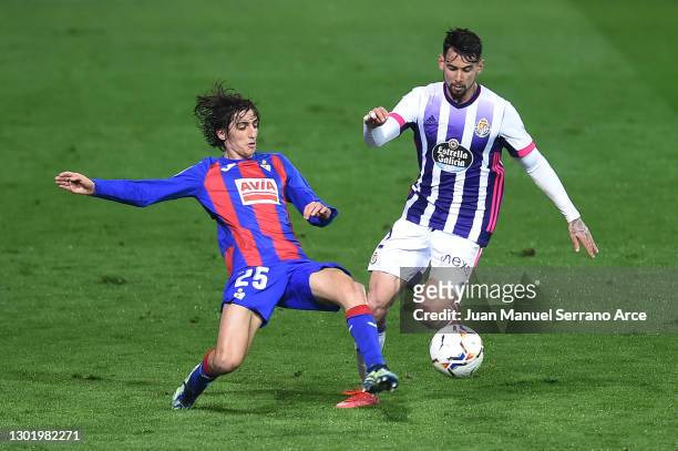Bryan Gil of SD Eibar battles for possession with Luis Perez of Real Valladolid during the La Liga Santander match between SD Eibar and Real...