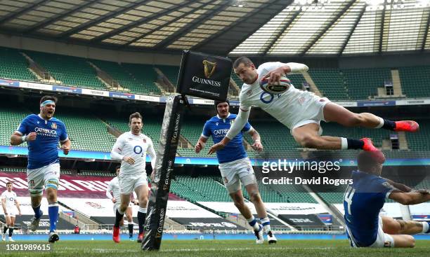 Jonny May of England dives over Luca Sperandio of Italy to score their side's third try during the Guinness Six Nations match between England and...