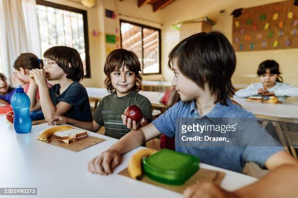 children in primary school eating at canteen - argentina girls stock pictures, royalty-free photos & images